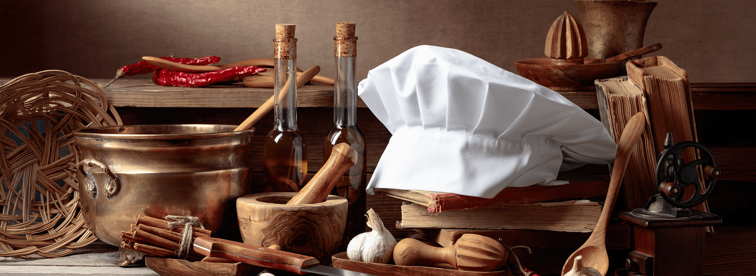 Chef's hat, vintage cookbooks, and old kitchen utensils